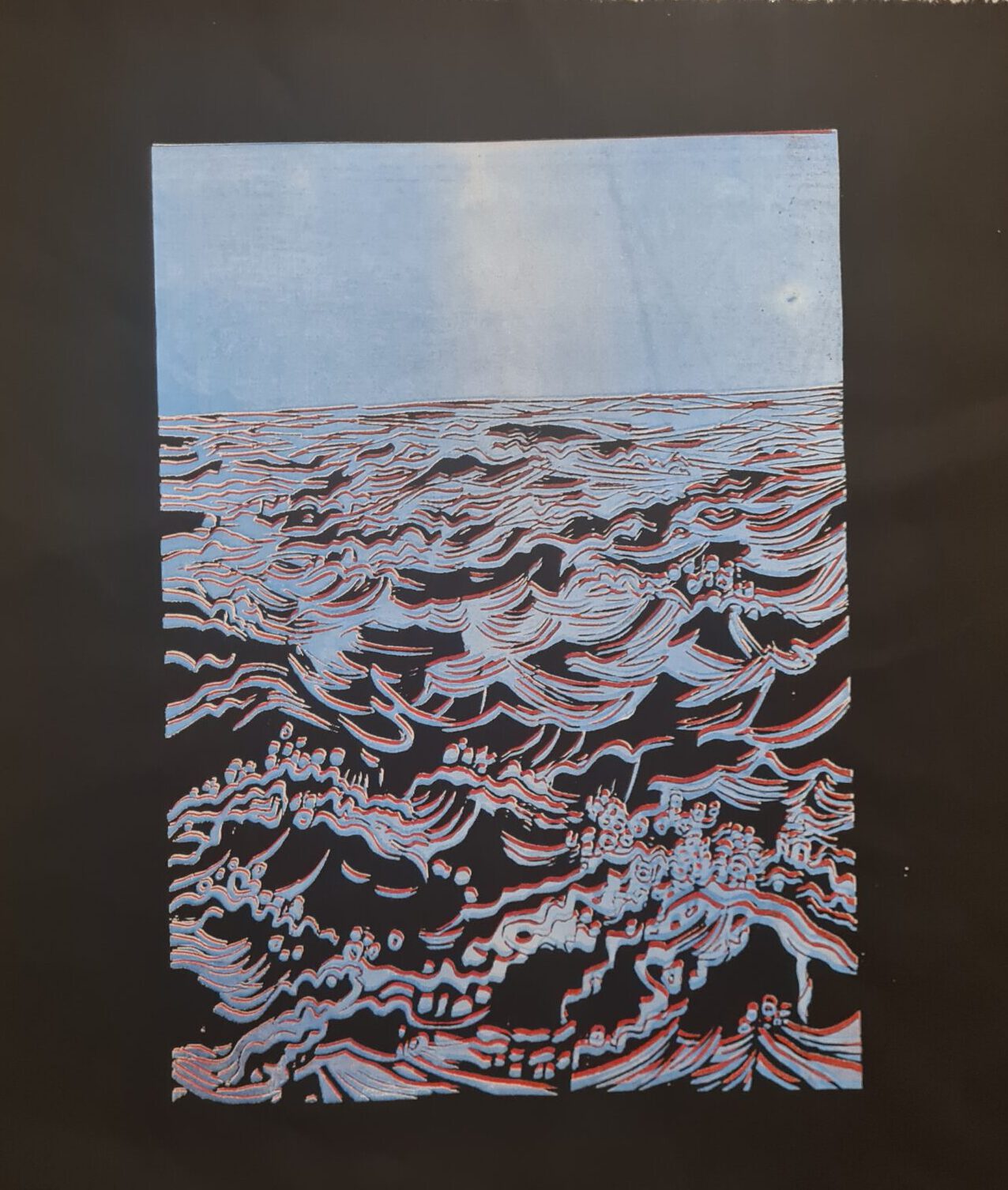 A linocut style print of waves. 3d effect with blue and red on black fabric.