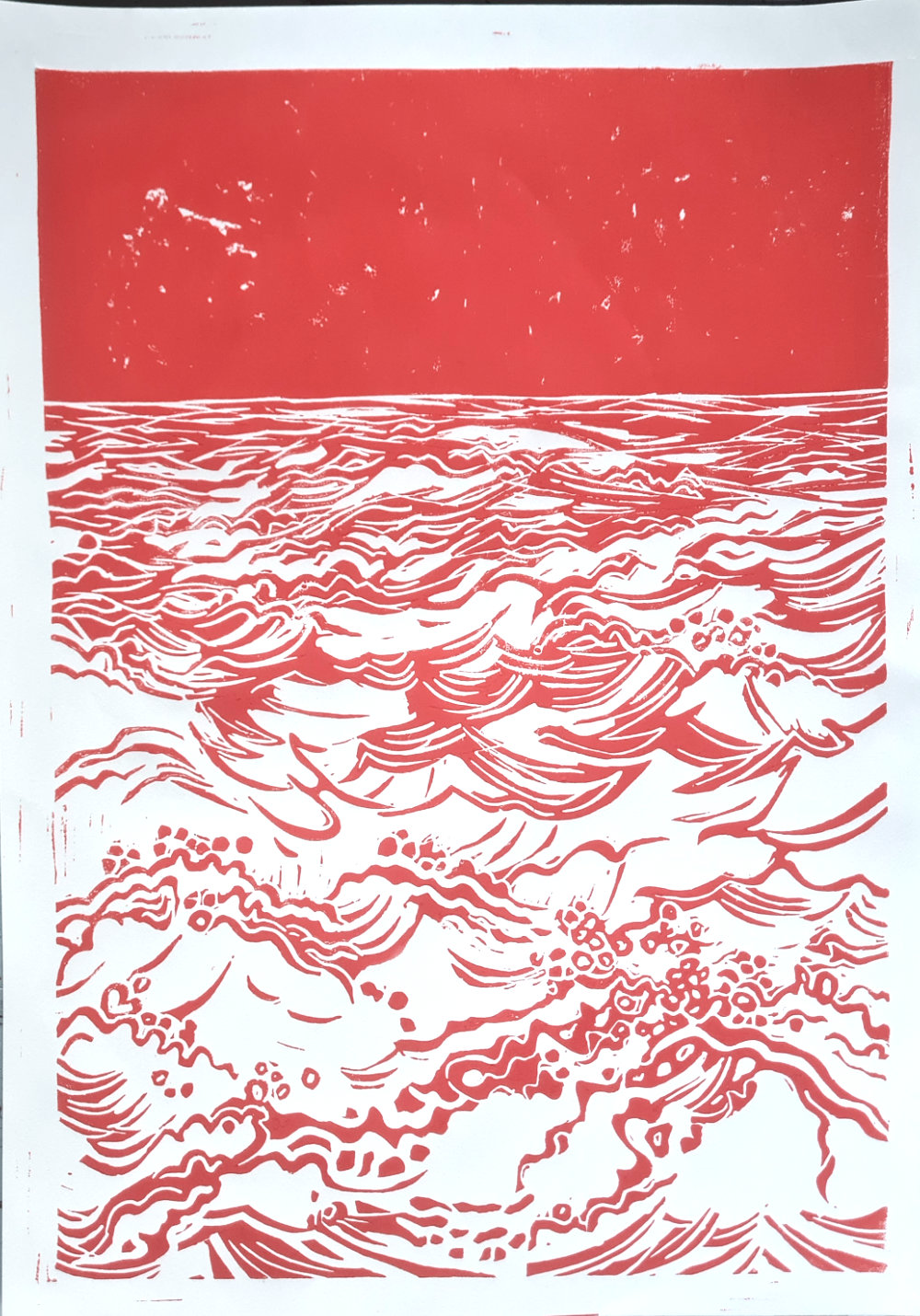 red linocut of waves